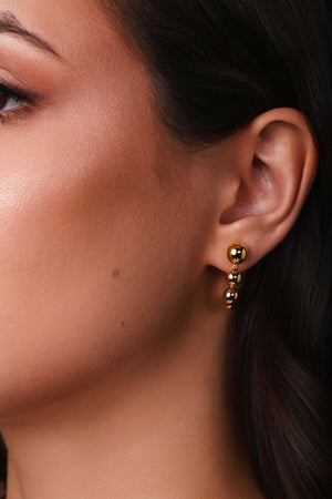 Brinco Palito Curvado Bolas Lisas Banhado a Ouro 18K